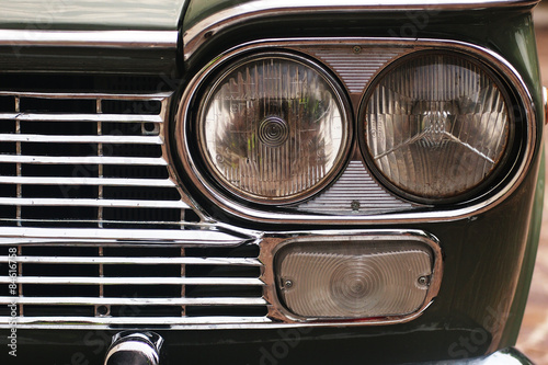 Italian style - detail of the headlight of an italian vintage car © andreamangoni