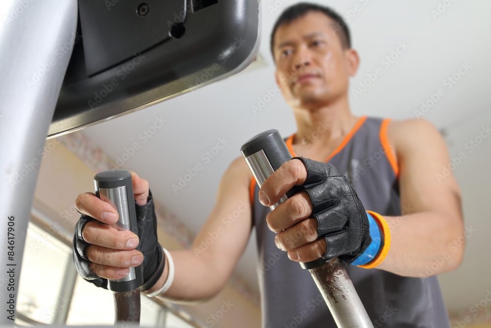 Exercising in the gym,Man walking on treadmill. Exercising in the gym,Man walking on treadmill.