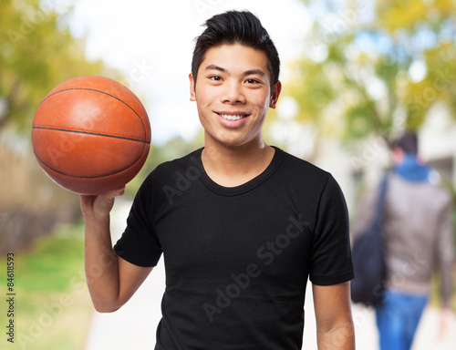 happy chinese sport man with basket ball