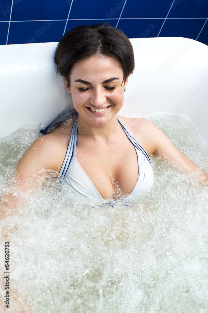 doctor makes a woman a massage at hydrobath