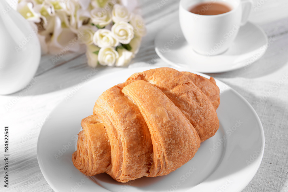 Delicious croissants on plate on table close-up Delicious croissants on plate on table close-up