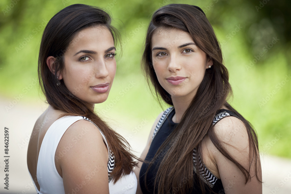 Two young women smiling at the camera Two young women smiling at the camera