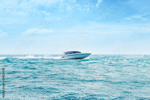 Big and luxury speedboat moving in the sea. Motor vessel.