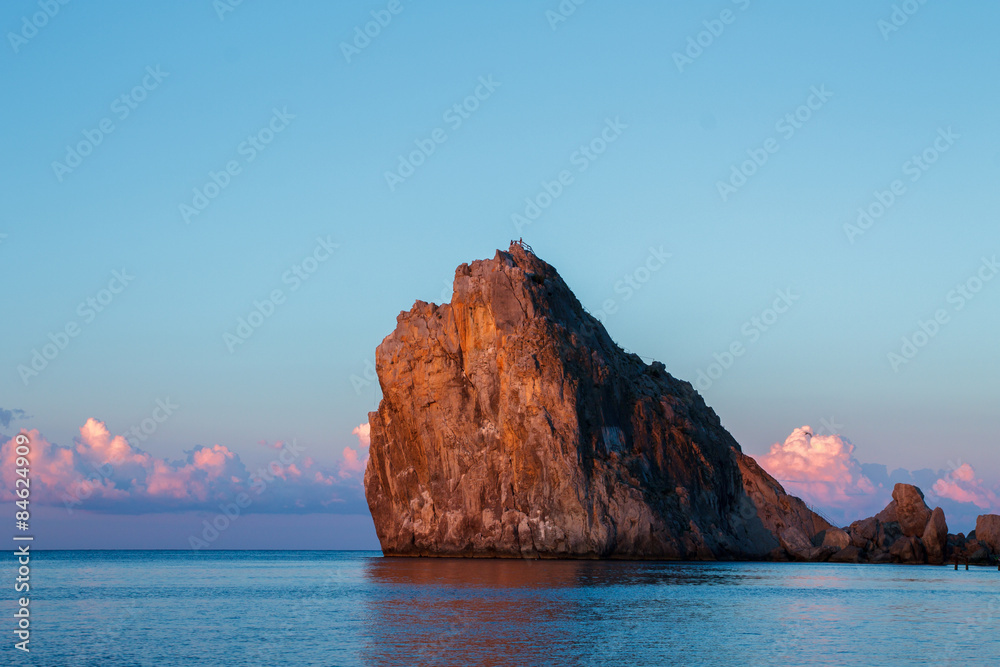 Rock in the sea at sunrise