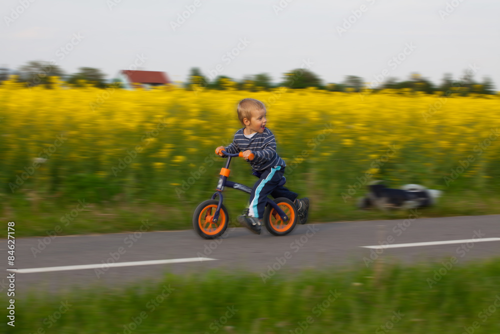 Little boy on a bicycle.