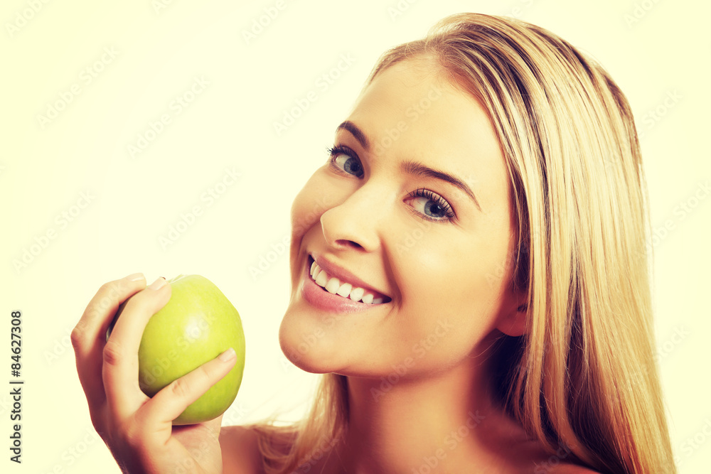 Smiling beautiful woman holding an apple Smiling beautiful woman holding an apple