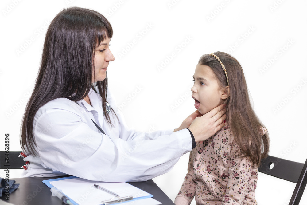 Woman pediatrician checking a child's throat on inspection, white background Woman pediatrician checking a child's throat on inspection, white background