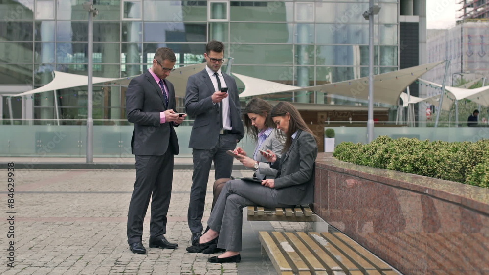 Businesspeople using smartphones and smiling to the camera
Businesspeople using smartphones and smiling to the camera