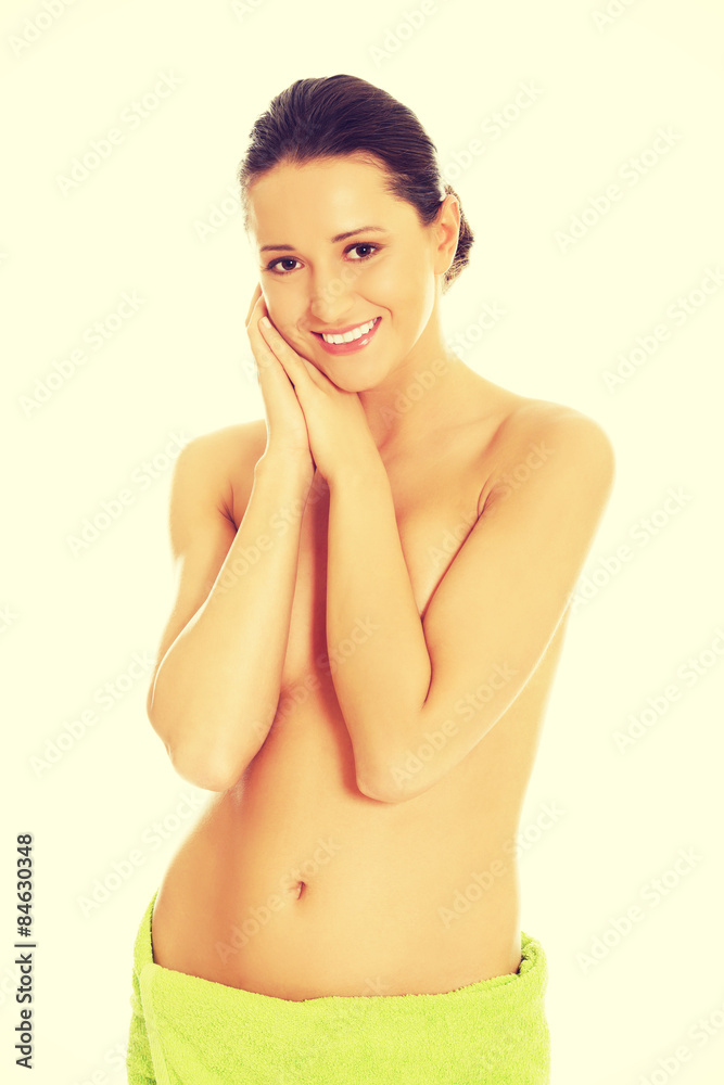 Fototapeta premium Beautiful happy woman wrapped in towel