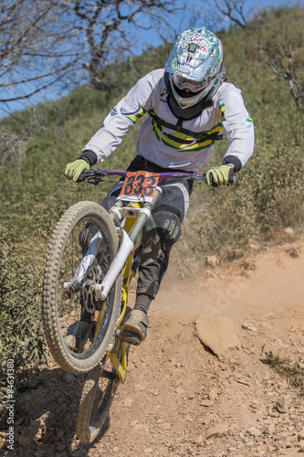 Downhill competition, Biker jumps fast in the countryside.