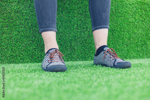 Feet of young woman on astro turf