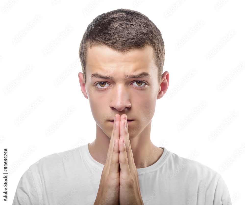 Young man praying or thinking Young man praying or thinking