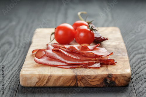 smoked ham prsut with cherry tomatoes and chili photo