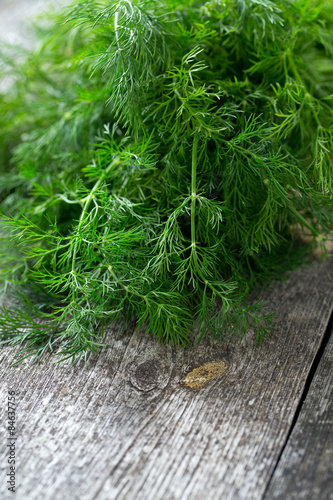 Fotografering bunch of dill on wooden surface