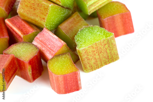 freshly cut pieces of rhubarb isolated on white background