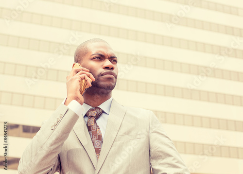 handsome young businessman talking on mobile phone