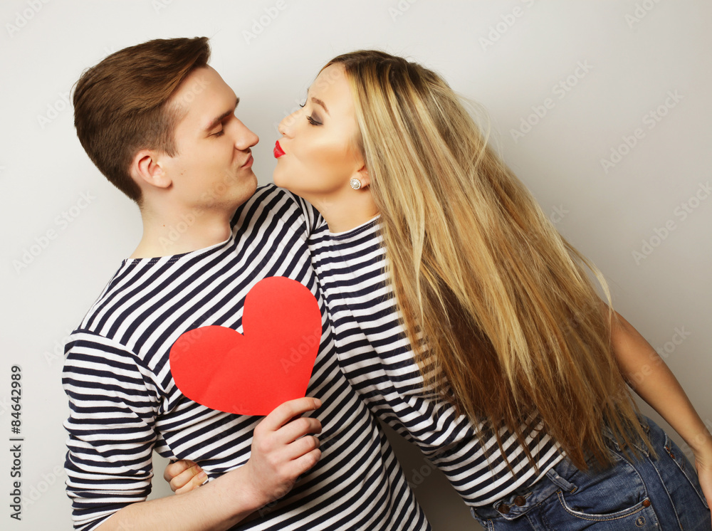 Happy couple in love holding red heart Happy couple in love holding red heart