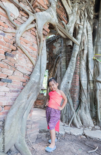 cute asian girl wear Thai dress at old temple location.