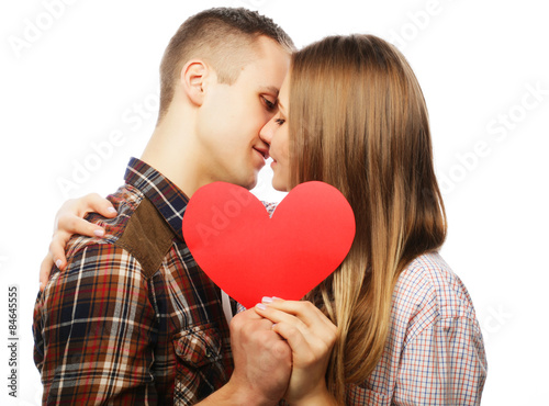 Happy couple in love holding red heart.