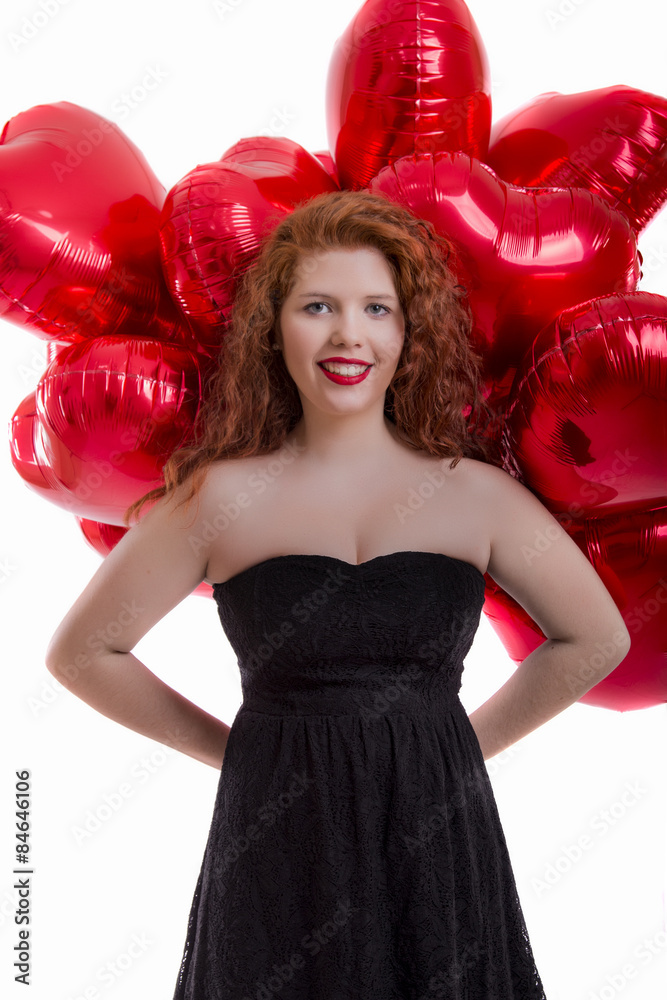 Close up view of a happy young girl with many red balloons. Close up view of a happy young girl with many red balloons.