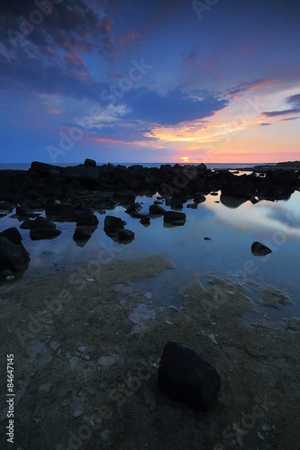 Sunset sky rocky shoreline