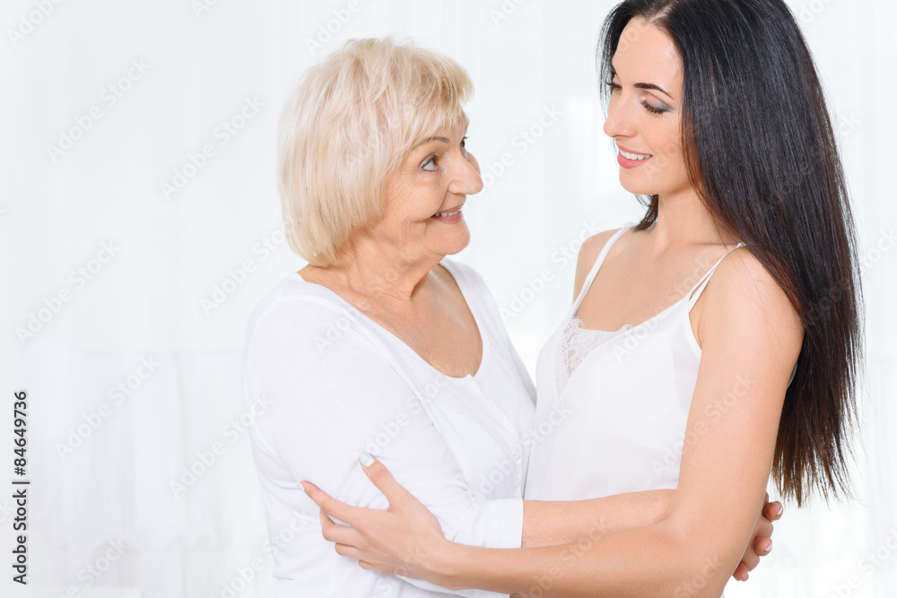 Granny standing and hugging granddaughter Granny standing and hugging granddaughter