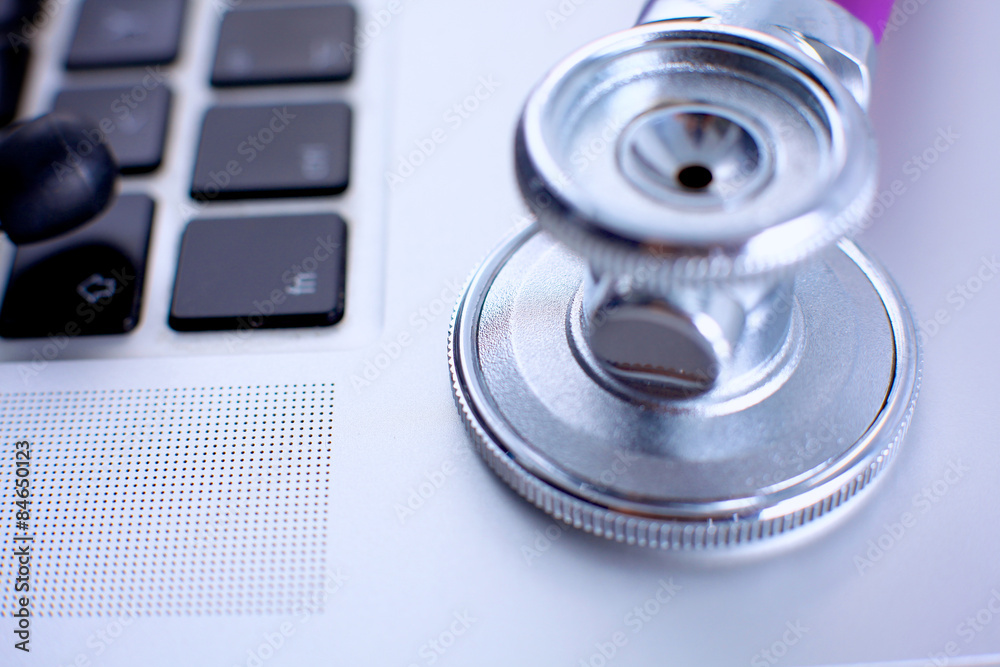 Violet stethoscope on a laptop computer Violet stethoscope on a laptop computer
