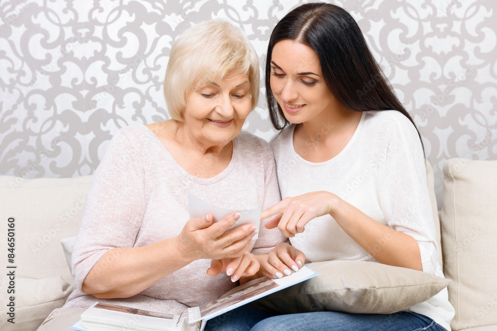 Granddaughter and her granny looking at photos Granddaughter and her granny looking at photos