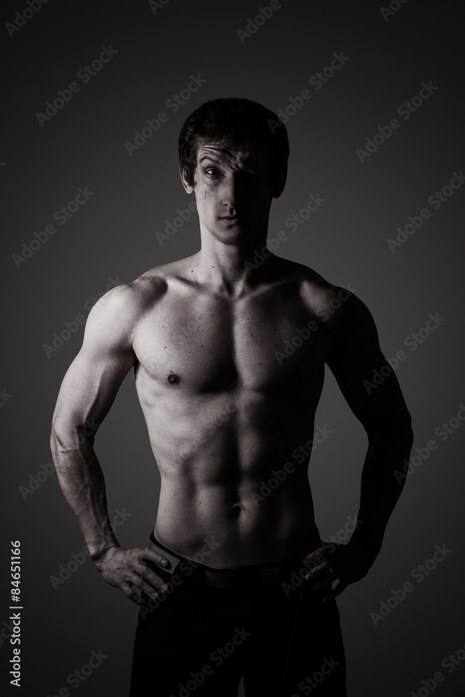 Studio portrait of a sporty young man in low key