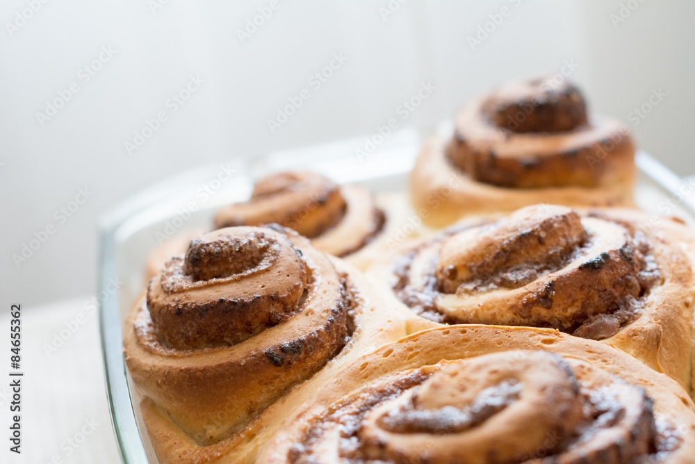 Homemade cinnamon buns (cinnabons) in glass dish, close up