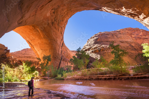 A hiker under Jacob Hamblin Arch in Coyote Gulch, Grand Staircase-Escalante National Monument. photo