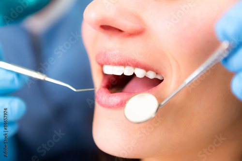 Details of white teeth of a man at during dentist surgery