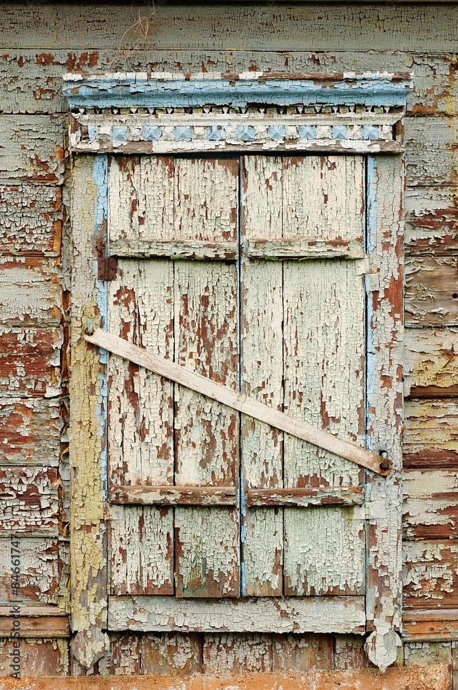 Naklejka premium Old wooden window with closed shutters