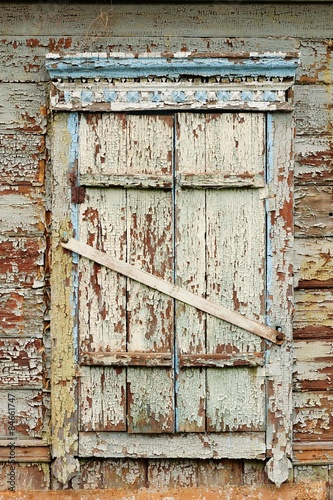 Old wooden window with closed shutters