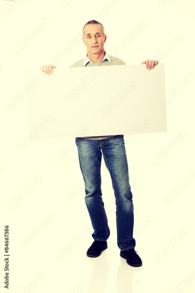 Mature man holding empty banner