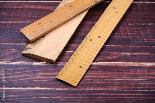 retro wooden ruler on wooden board photo