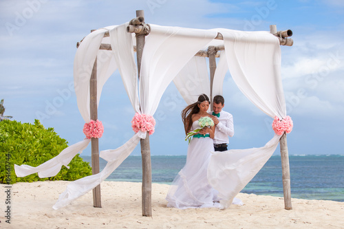 Young loving couple wedding in gazebo.