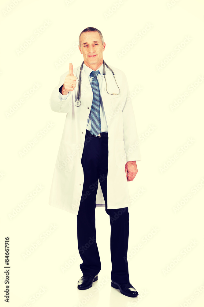 Full length confident male doctor with thumb up Full length confident male doctor with thumb up
