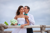 Bride and groom together on a wharf