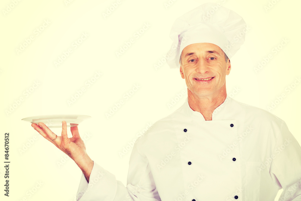 Chef holding white porcelain plate Chef holding white porcelain plate