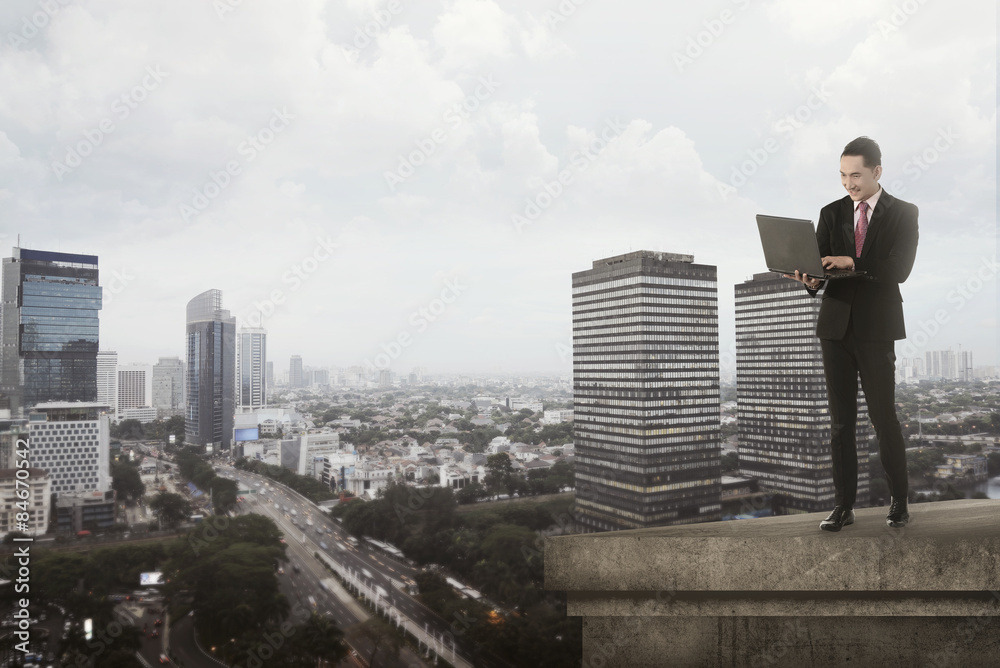 Asian Business Man Using Laptop On The Rooftop Asian Business Man Using Laptop On The Rooftop
