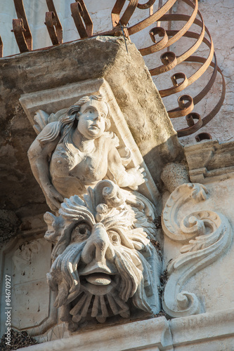 View of some typical baroque mascarons under the balconies of Cosentini Palace in Ragusa Ibla, Sicily