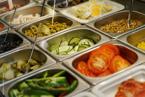 Fresh fast food in trays prepared for quick meal in a fast food restaurant photographed from above with selective focus, diagonal composition