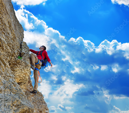 man climbing on rock