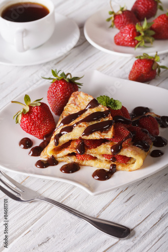 crepes with strawberries and coffee close-up. Vertical
