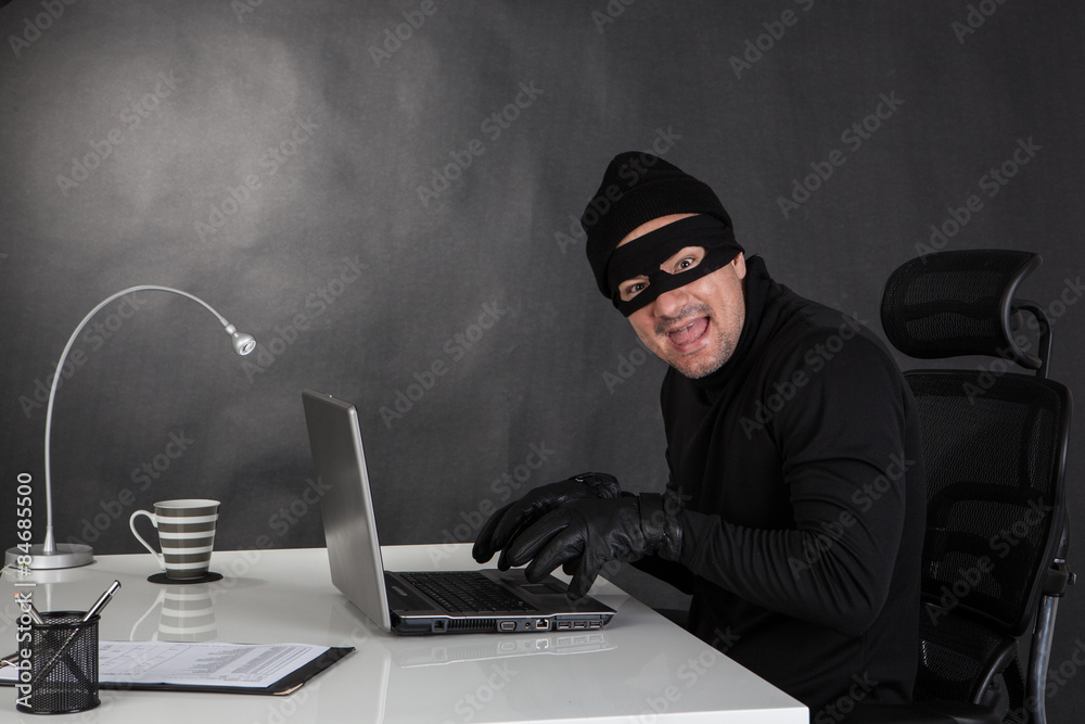 Hacker stealing data and laughing Hacker stealing data and laughing