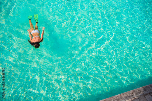 Young girl snorkeling in tropical water on vacation