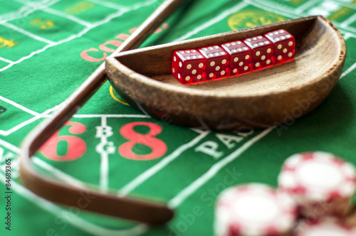 Фотография 5 Dice in a bowl and a stick on a craps table