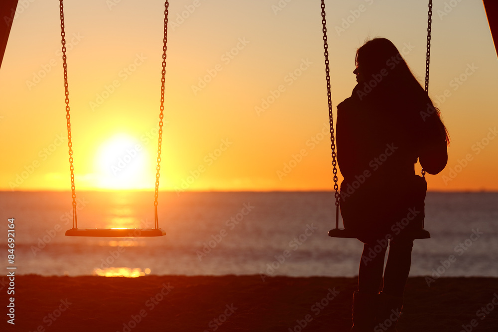 Single woman alone swinging on the beach - obrazy, fototapety, plakaty 