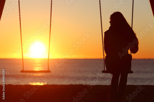 Fotografie, Obraz Single woman alone swinging on the beach